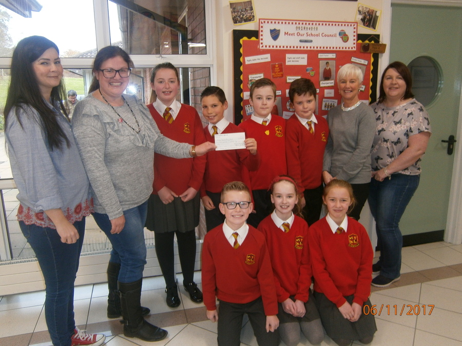 Parents Group representatives hand over a cheque for £700 to school council members