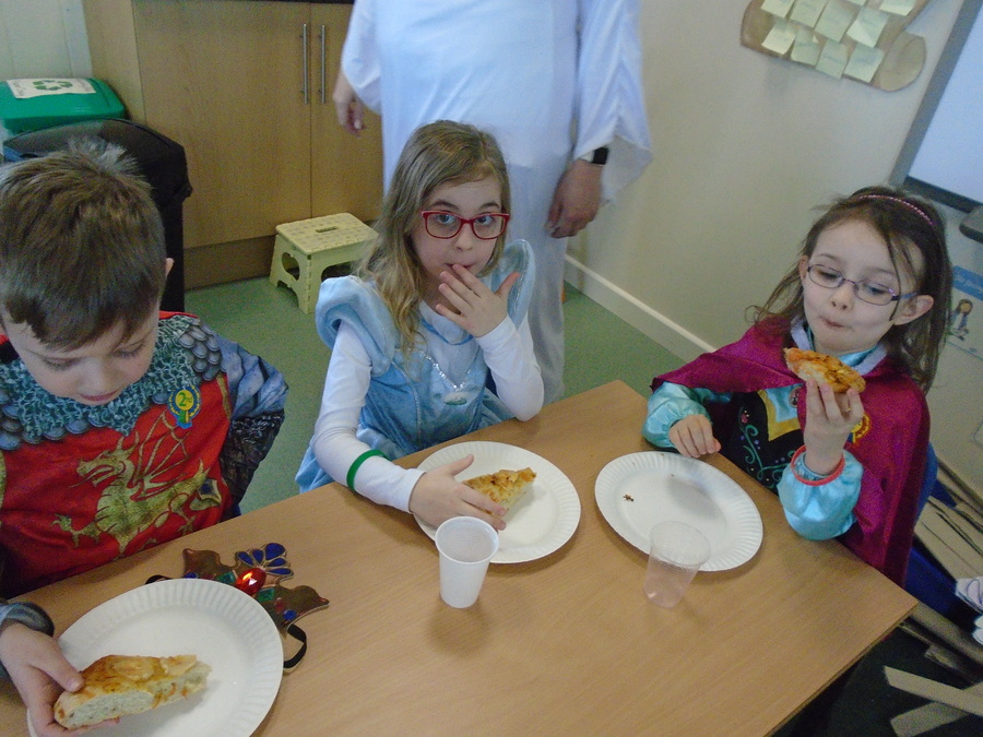 Eating the Medieval Pizza's we made.