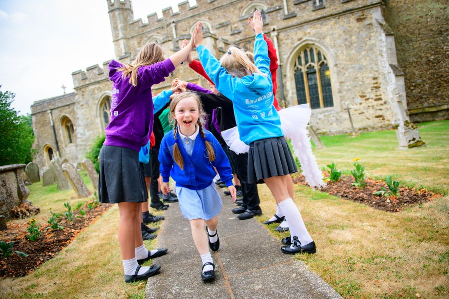 Year 6 Leavers form a traditional human archway at the end of the Founder's Day Service. Photo Credit: Gareth Squance