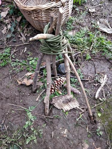 Indi worked alone and just placed an object on a stick and was surprised that it fell off.  She then found the string and sticks independently.  Another child helped her tie a knot.  She was proud of what she created.  the cone was the animal that would s
