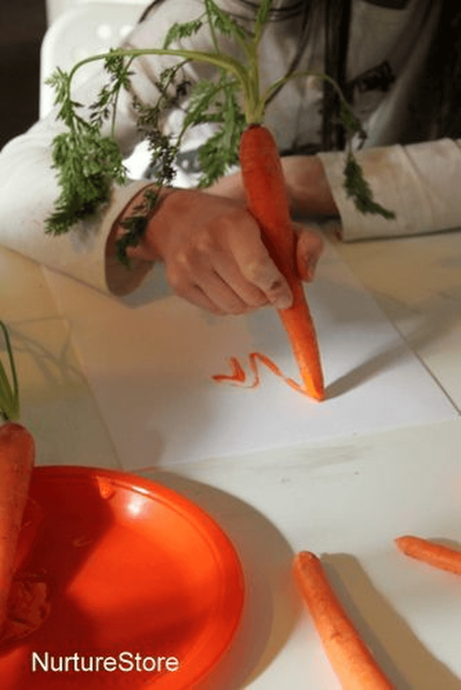 Practice writing your sounds using a carrot. Can you write the names of the different vegetables from the story?