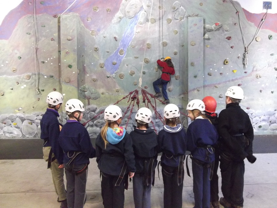 Team work helps Amy climb and then abseil down the climbing wall.