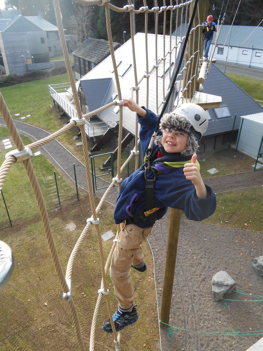 Shane hovers high above the ground on the high ropes course.