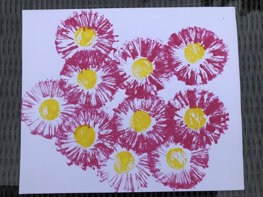Pink Flowers using straight cut cardboard stamp and a milk bottle top for the middle
