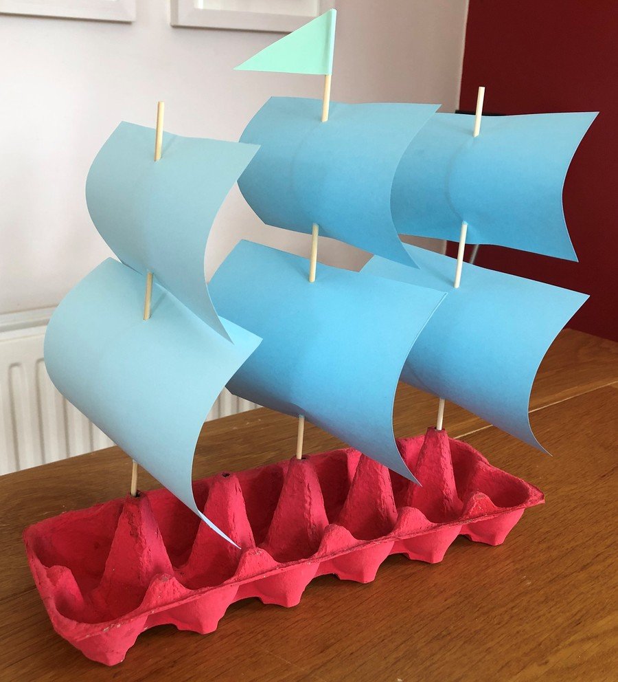 Red egg box sailing ship with three lots of sails