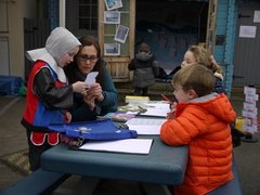 EYFS writing outside with SC.JPG