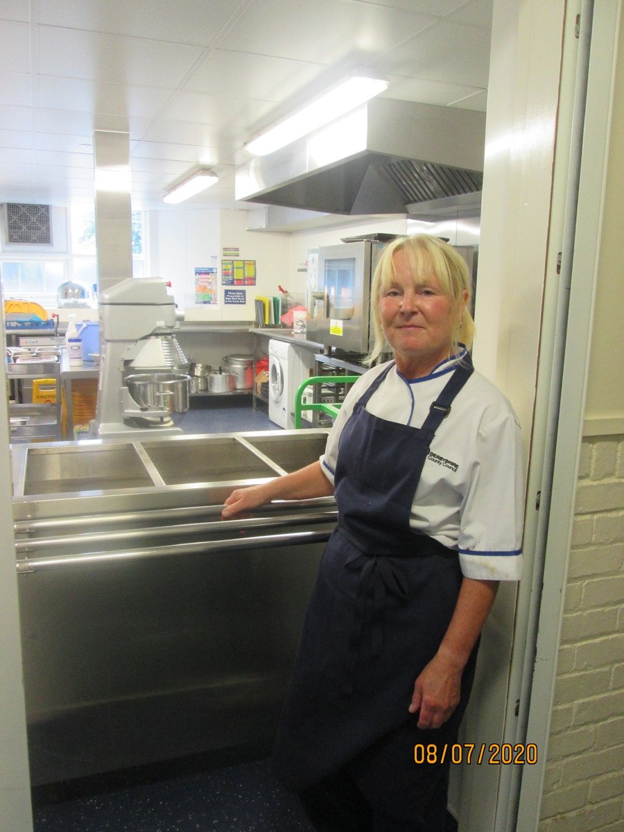 This is Jane. She is our school cook. She will serve you your dinner.