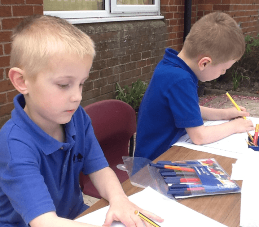 Children writing outside