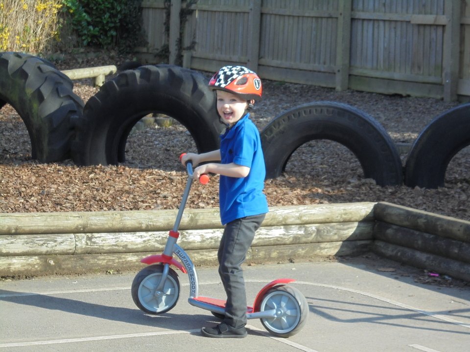 North Cave school child riding a scooter