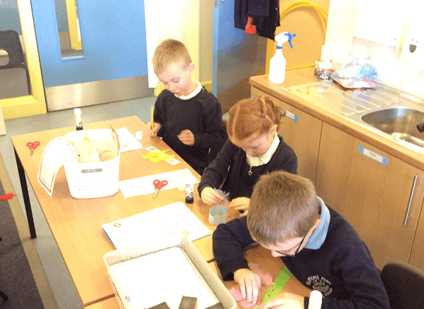 Pupils in Lime Tree Class using their own instructions to make their friendship bracelets
