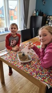 Isla helping her brother with his science experiment 