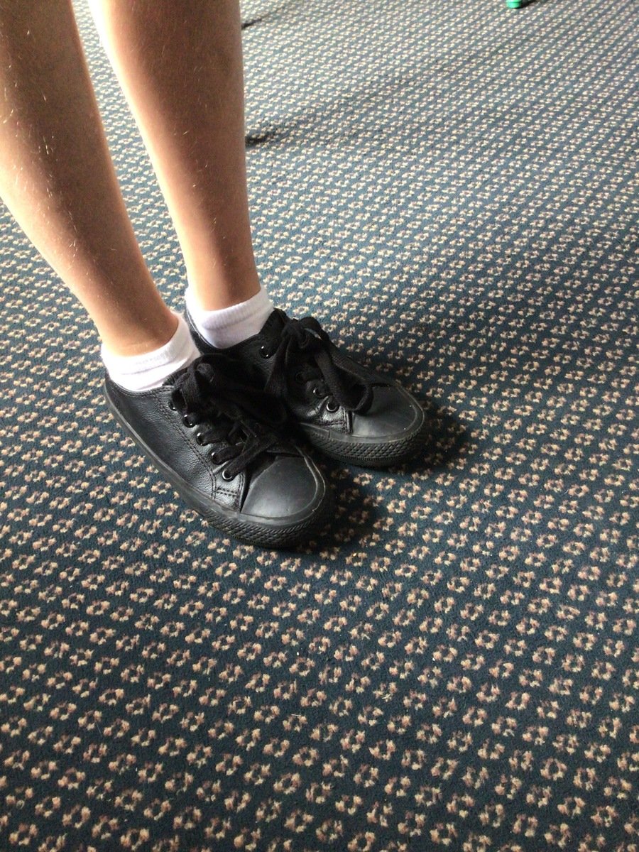 An example of the black trainer style shoe that children are  wearing