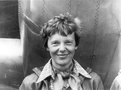 Amelia_Earhart_standing_under_nose_of_her_Lockheed_Model_10-E_Electra,_small.jpg