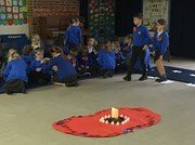 Class 2 gave out poppies they had made.