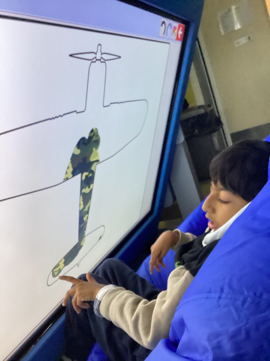 T- Pathway 1- Year 2. T chose a camouflage effect to paint his plane on the interactive touchscreen, super focus T!