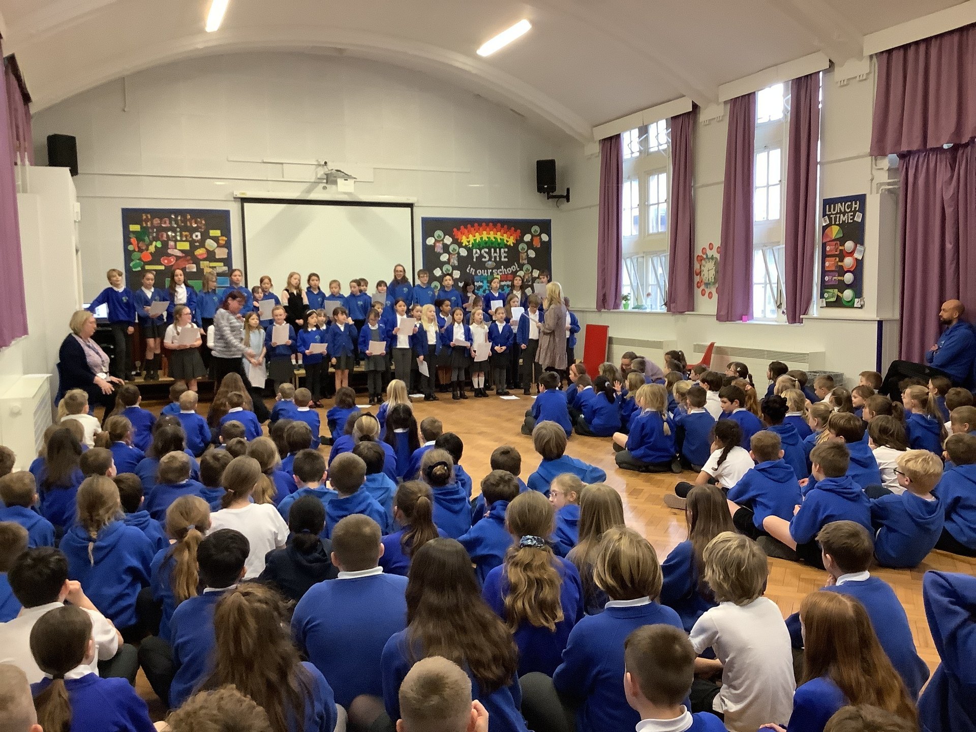 Key Stage Two choir performing in assembly