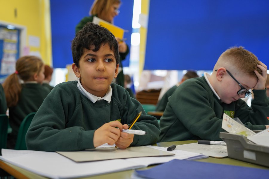Children enjoying learning in a year 2 classroom.