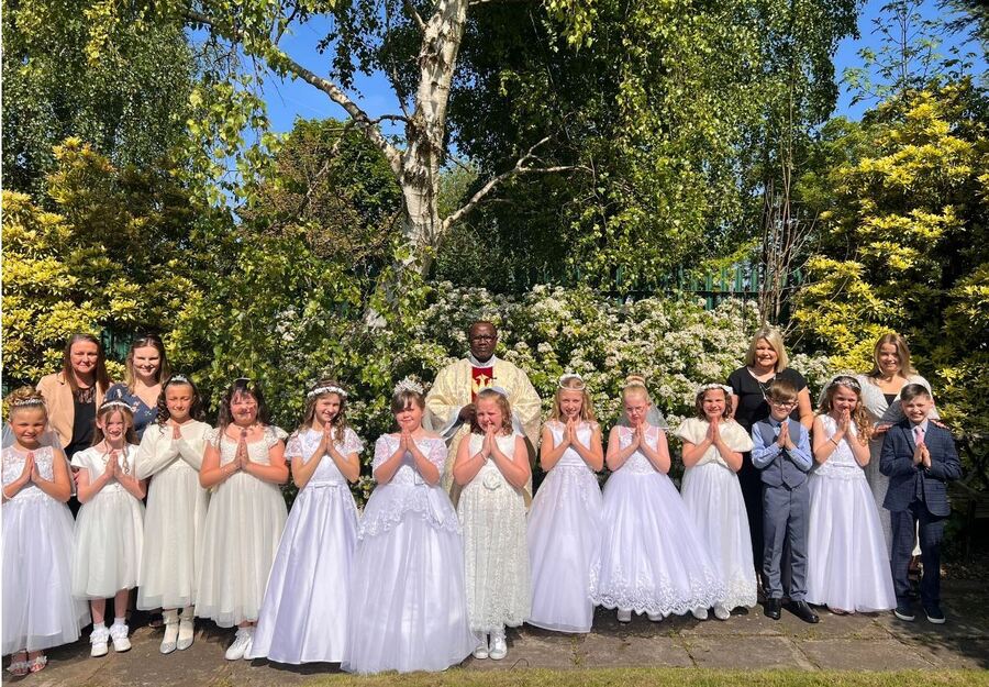 Our First Holy Communicants of 2023  in the parish garden of St Vincent de Paul Church with Father Jean Paul