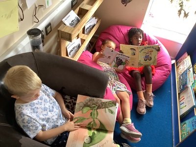 Independent story reading in the book corner.JPG