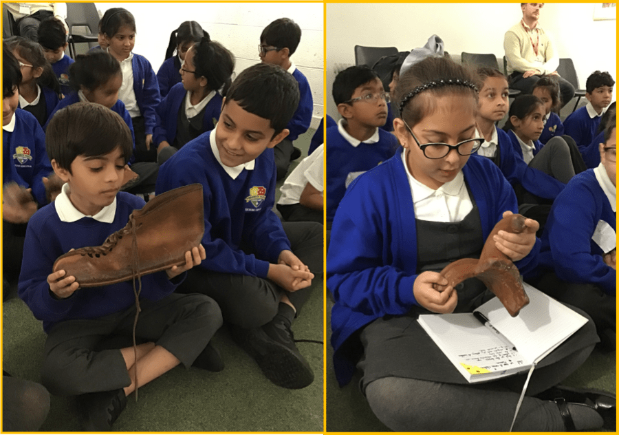 Year 4 children handling real and replica Roman artefacts. 