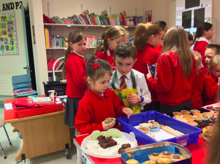 Lee helps some of the younger children to choose some buns.