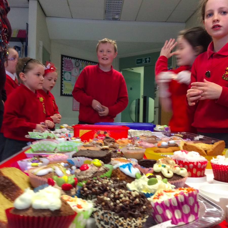 Daniel checks that sellers in P.3/4: Cara and Aidin are drumming up business.