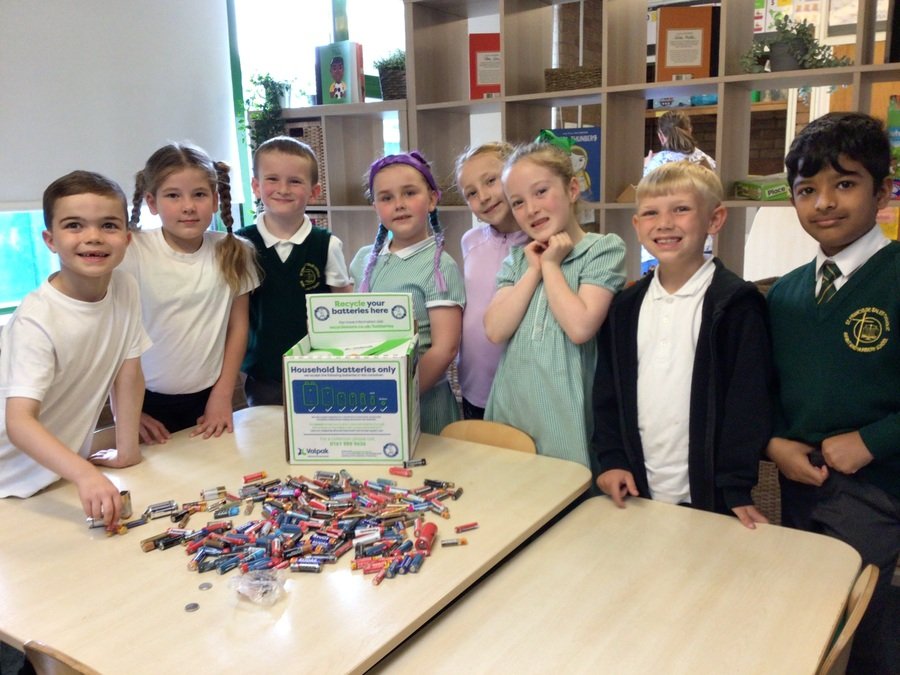 Year 2 School Council with some of the 242 batteries we collected for our recycle to read collection!