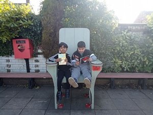 Year 3 relaxing with a book outside 1.jpg