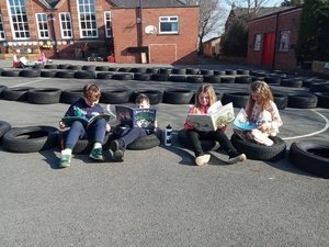 Year 3 relaxing with a book outside 2.jpg