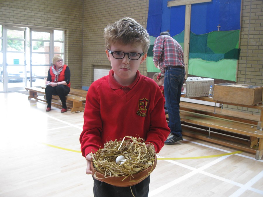 Ethan holds a clay dish with two eggs newly laid by one of Joe's pigeons.