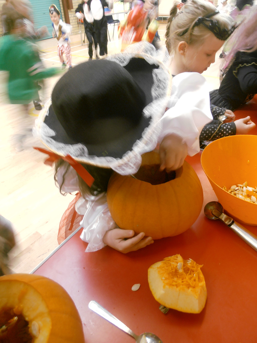 Molly P.2D carving a pumpkin