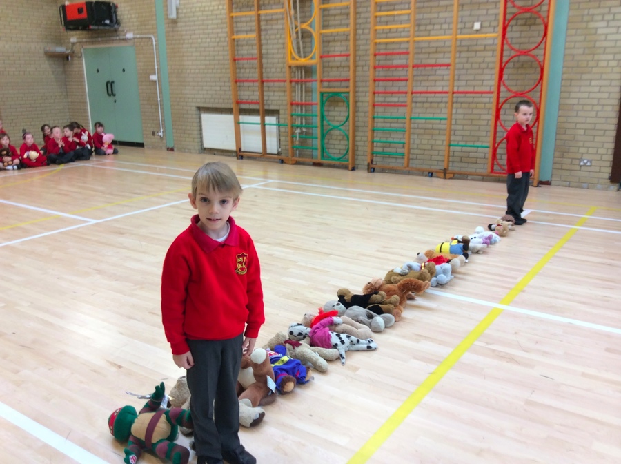 Ethan and Ryan are standing beside the tallest and shortest teddies in P.2W