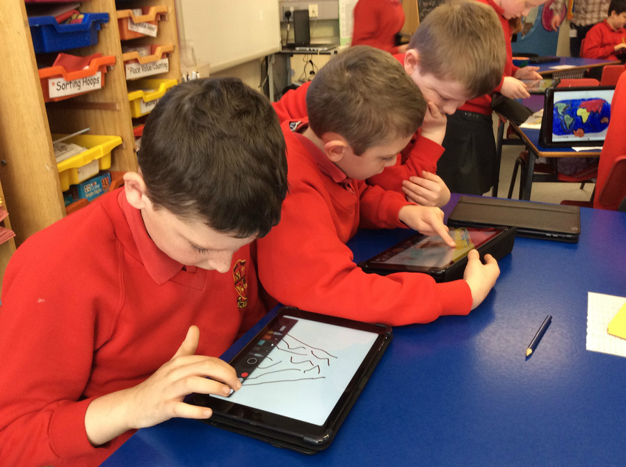Ben, Darragh and Joshua design and draw their volcano.