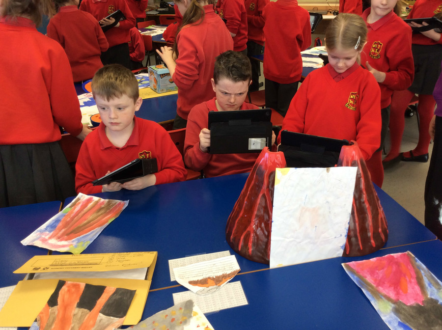 Joshua, Owen and Katie take images using the iPads.