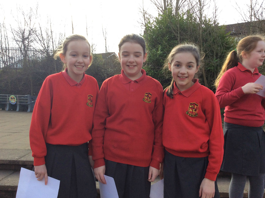 P.6S girls try to cast a shadow of the eclipse from a pinhole viewer onto a white page.