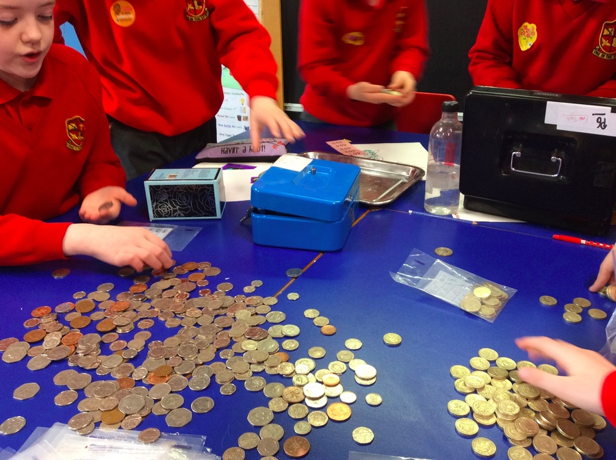 P.6 enjoy counting the proceeds from the bun sale.  The photographer obviously thought the money was more important the children's faces!!