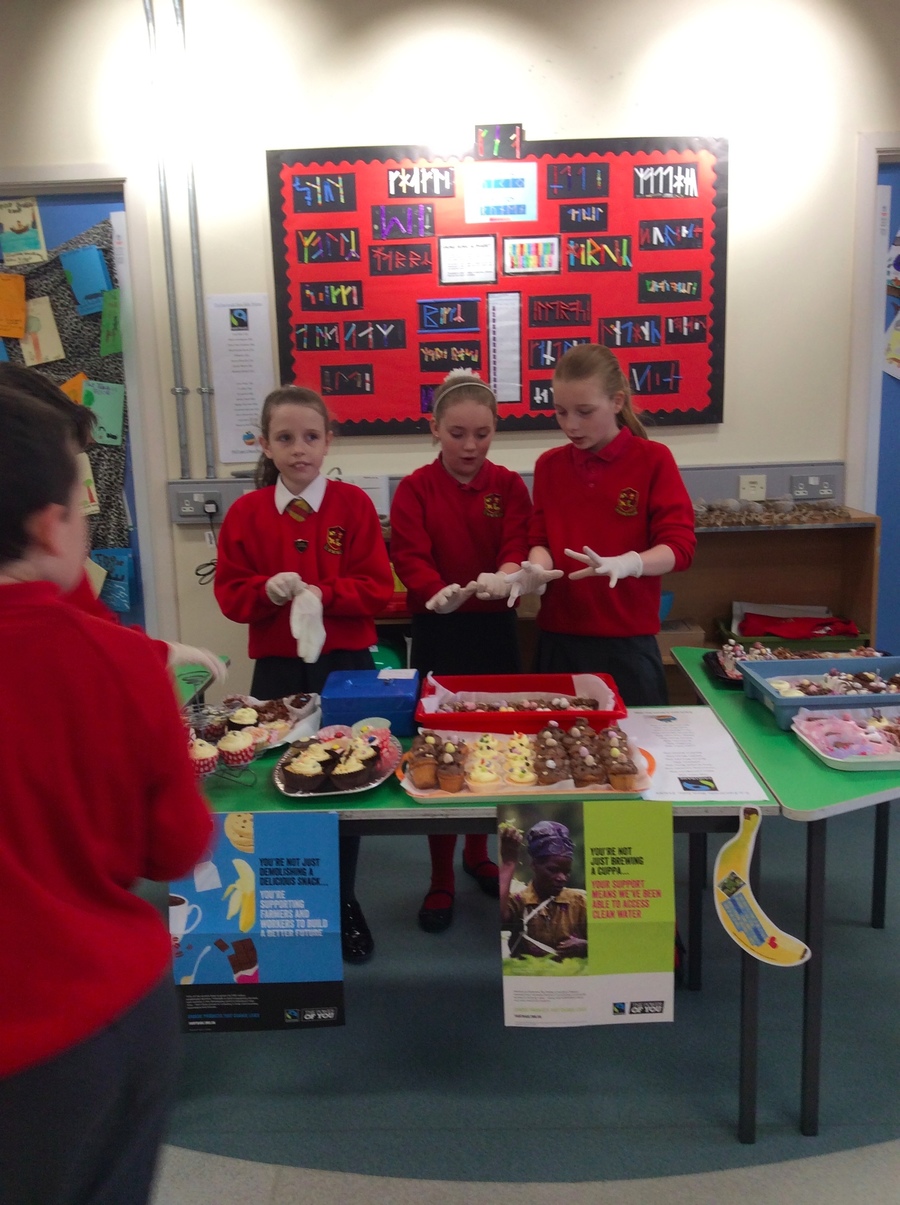 Morgan, Holly and Emilie put on their gloves ready to sell in P.5/6 area.