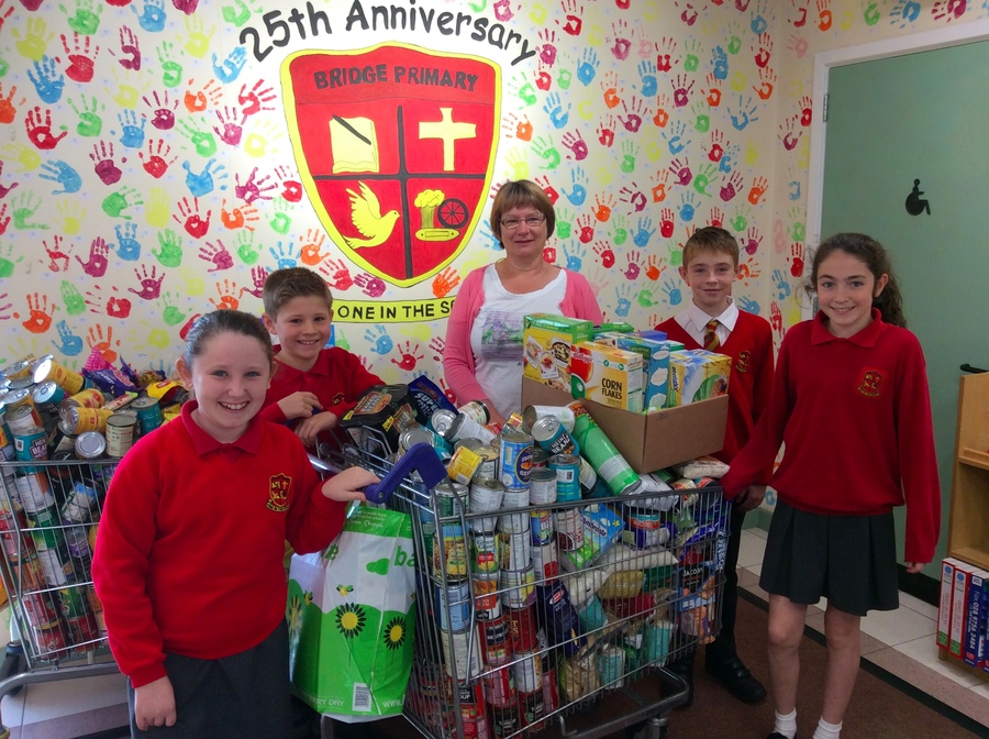 Mrs Kerr from Storehouse Banbridge gratefully accepts a trolley full of food.