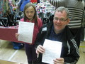 David McKay, Tesco Community Champion with Adelle at the Craft Sale, showing the ECO treasure hunt details.jpg