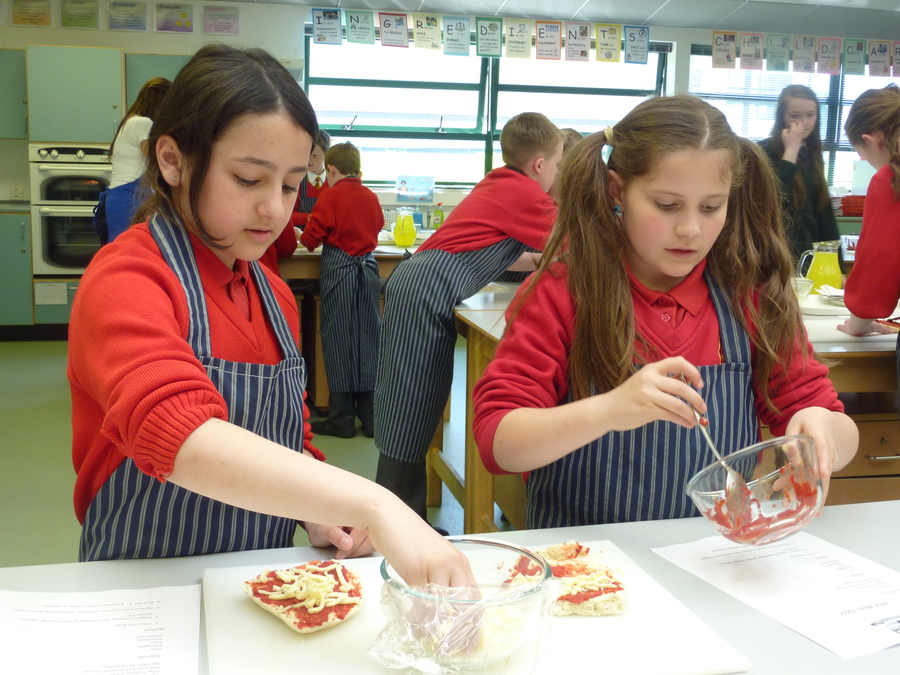 Samiha and Olivia enjoying making a pizza.