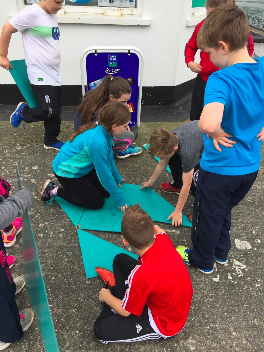 working as a team to solve the tangram puzzle.