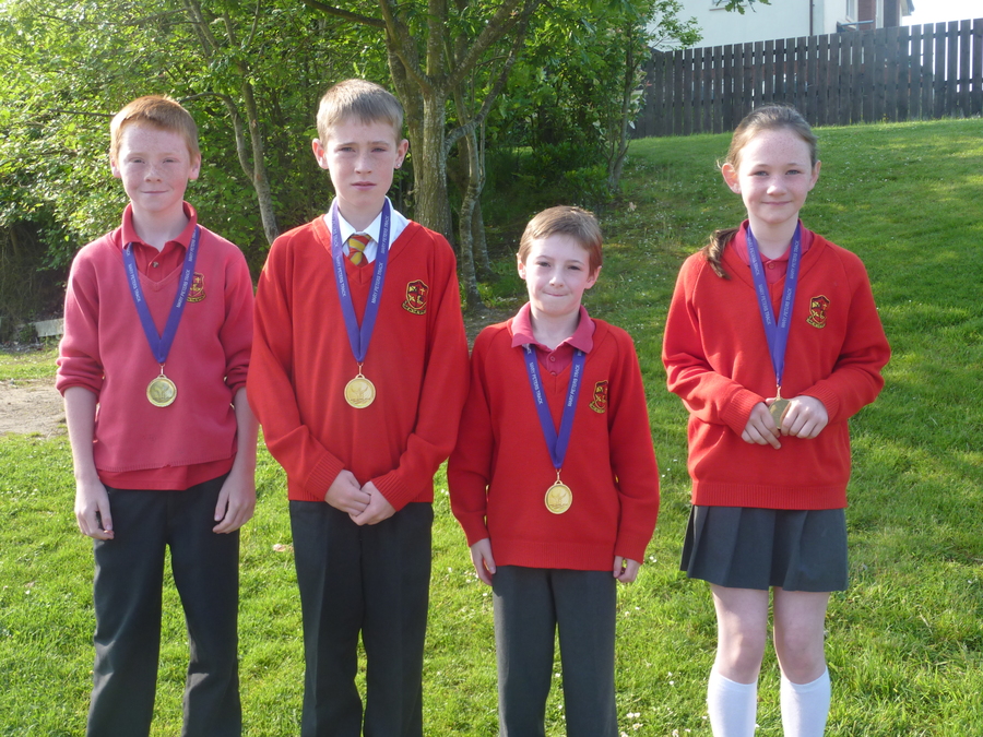Ronan, Deon, Nathan and Jessica proudly show off the medals they received at the opening of the new Mary Peter's Track.