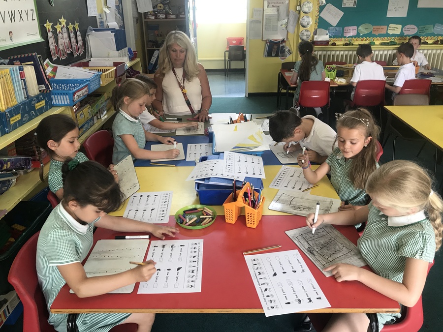 Children enjoying learning in a year 2 classroom.